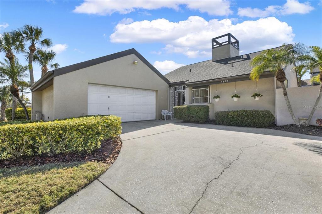 4684 West Huron Road St. Petersburg, FL 33708 - Photo 30 of 31 a front view of a house with a yard and garage