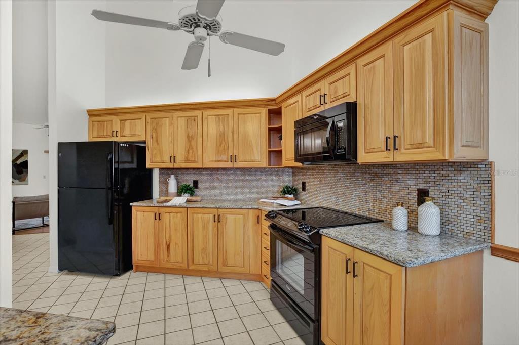 4684 West Huron Road St. Petersburg, FL 33708 - Photo 8 of 31 a kitchen with stainless steel appliances granite countertop a refrigerator a stove a sink and dishwasher