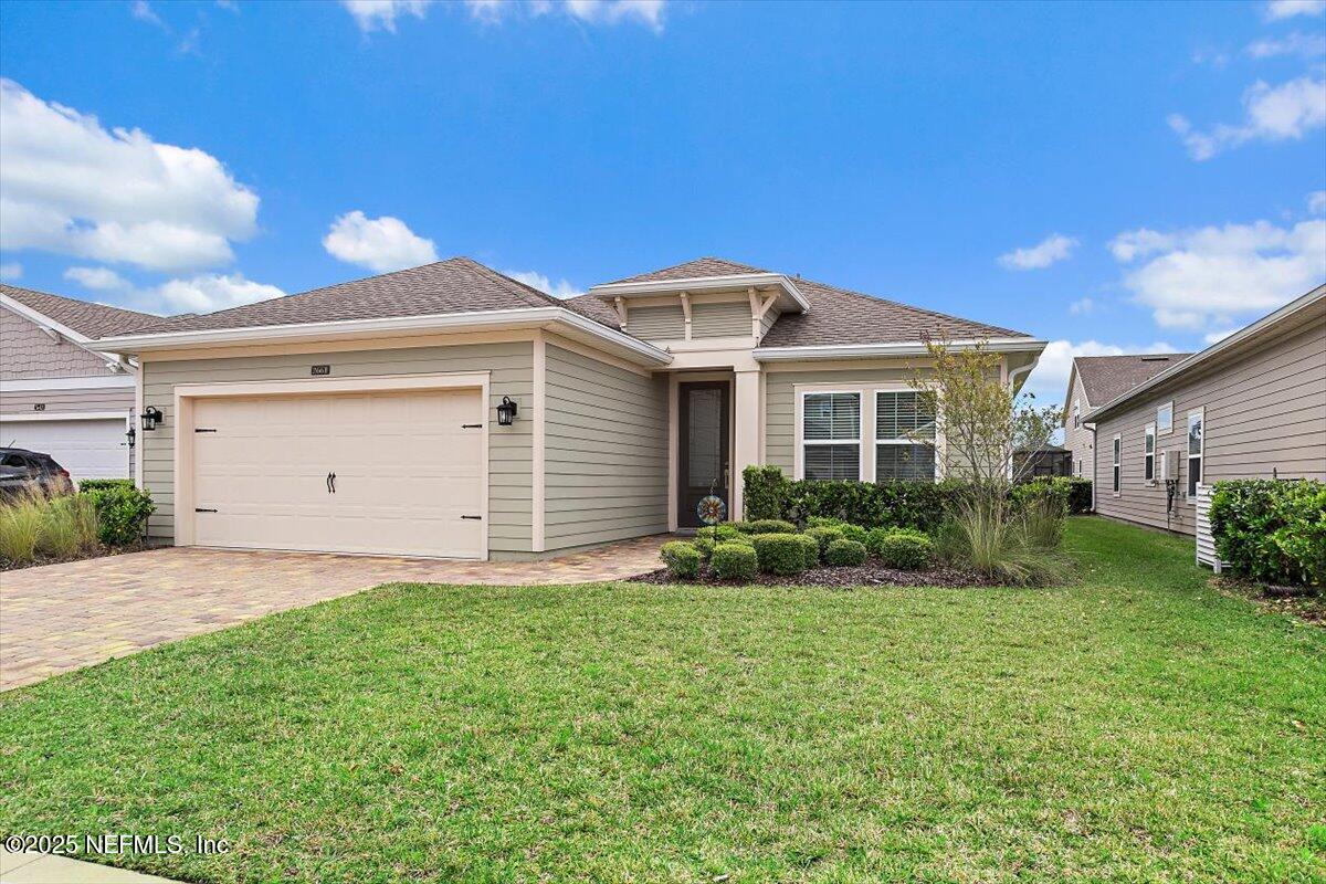 a front view of a house with a yard and garage
