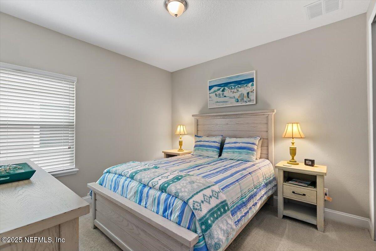 2661 Alexia Circle Jacksonville, FL 32246 - Photo 11 of 22 a bedroom with a bed and a night stand