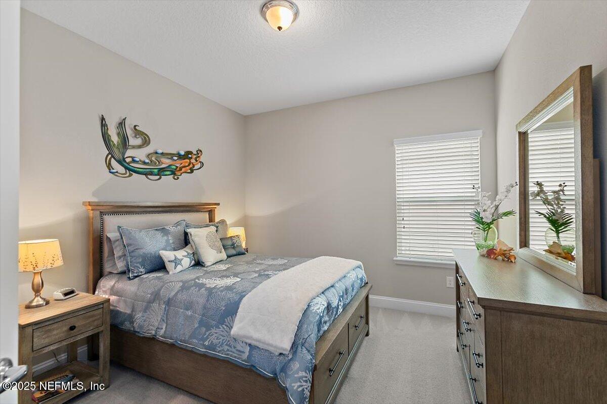 2661 Alexia Circle Jacksonville, FL 32246 - Photo 13 of 22 a bedroom with a bed and a desk