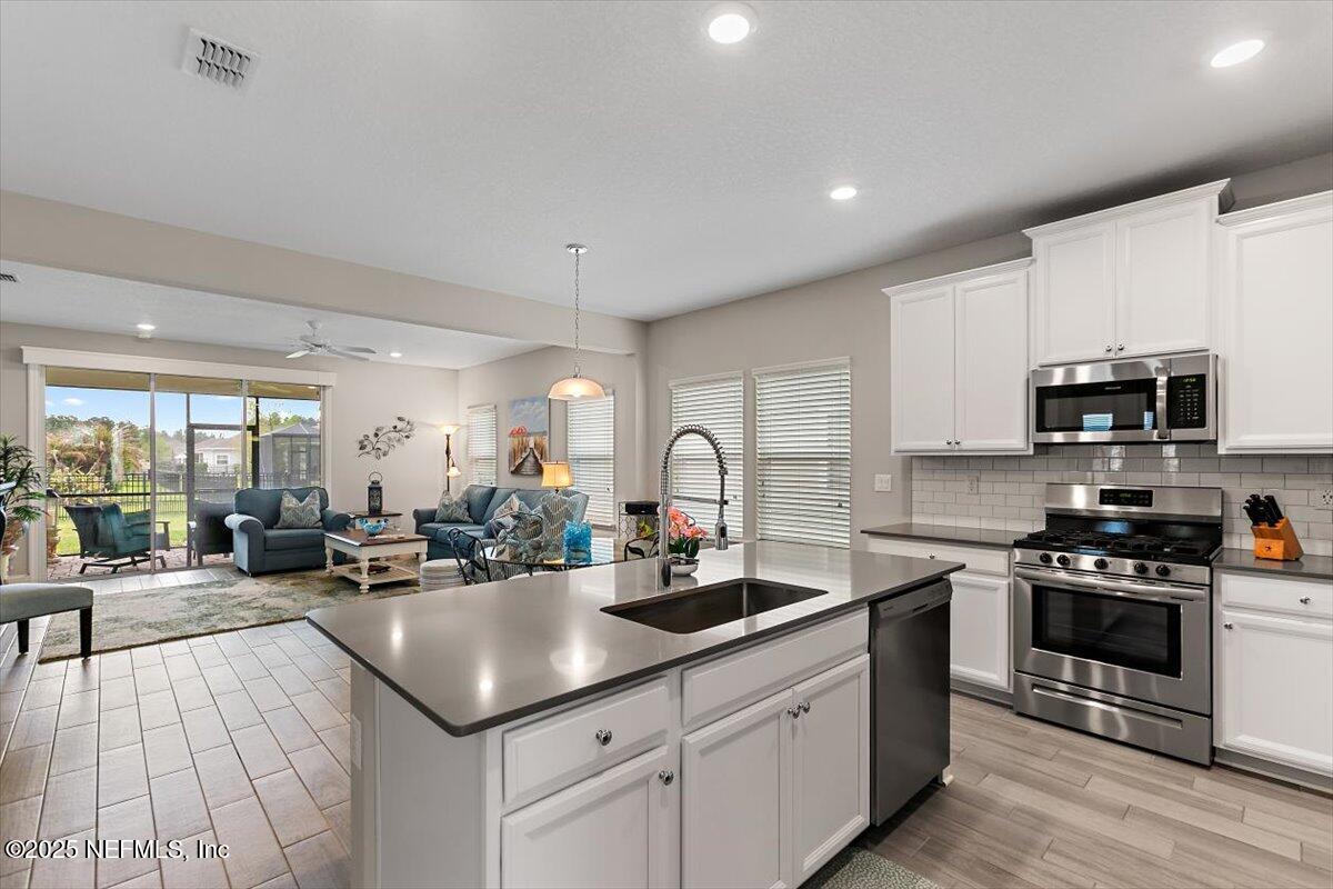 2661 Alexia Circle Jacksonville, FL 32246 - Photo 4 of 22 a kitchen with stainless steel appliances granite countertop a sink counter space a stove and cabinets