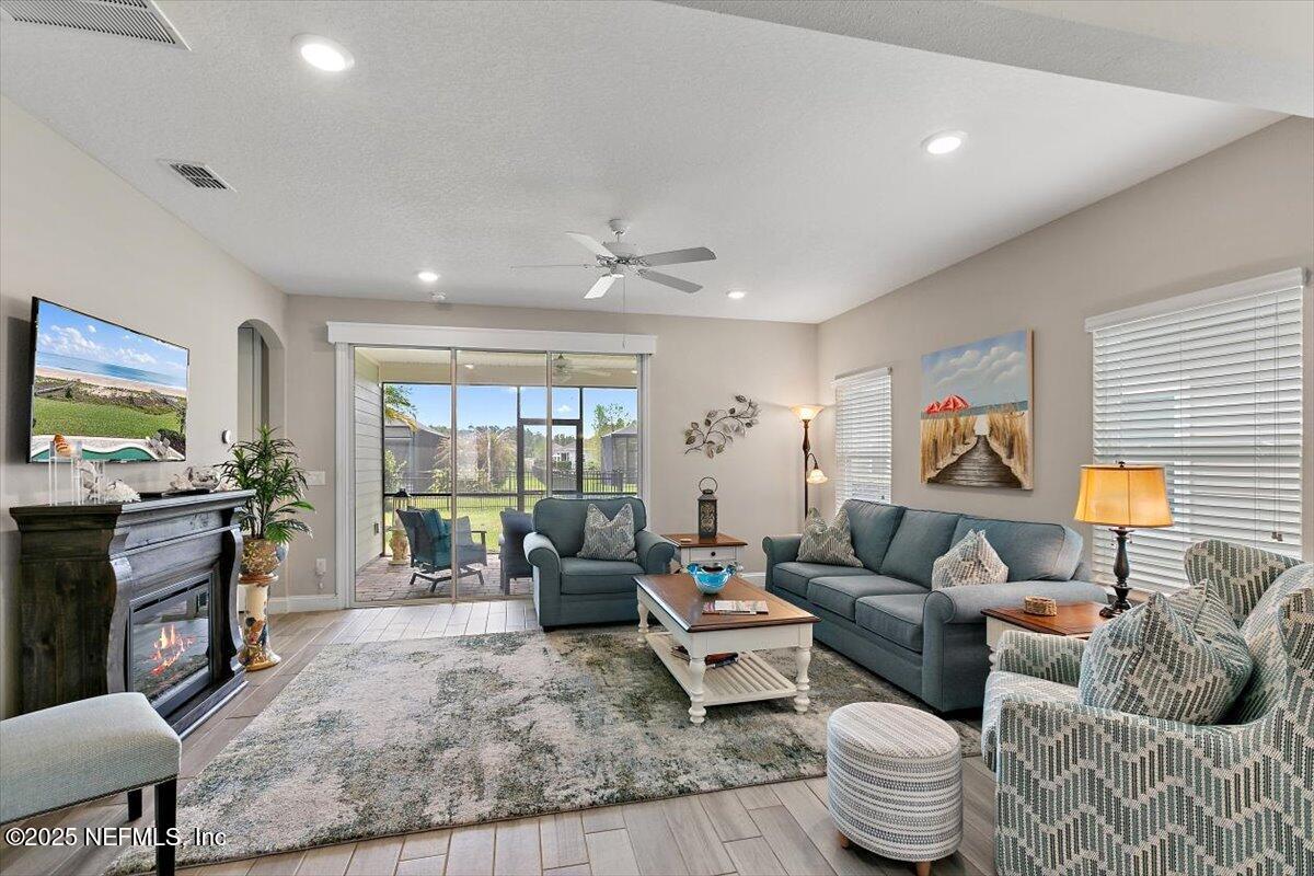 2661 Alexia Circle Jacksonville, FL 32246 - Photo 6 of 22 a living room with furniture and a flat screen tv