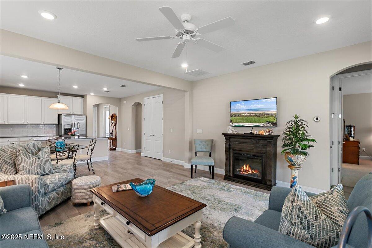 2661 Alexia Circle Jacksonville, FL 32246 - Photo 7 of 22 a living room with furniture a fireplace with wooden floor