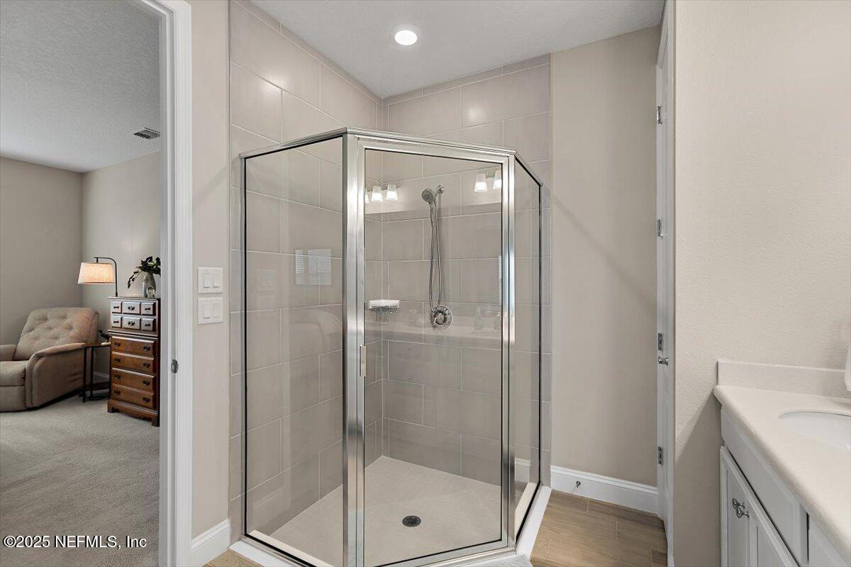 2661 Alexia Circle Jacksonville, FL 32246 - Photo 10 of 22 a bathroom with a glass shower door