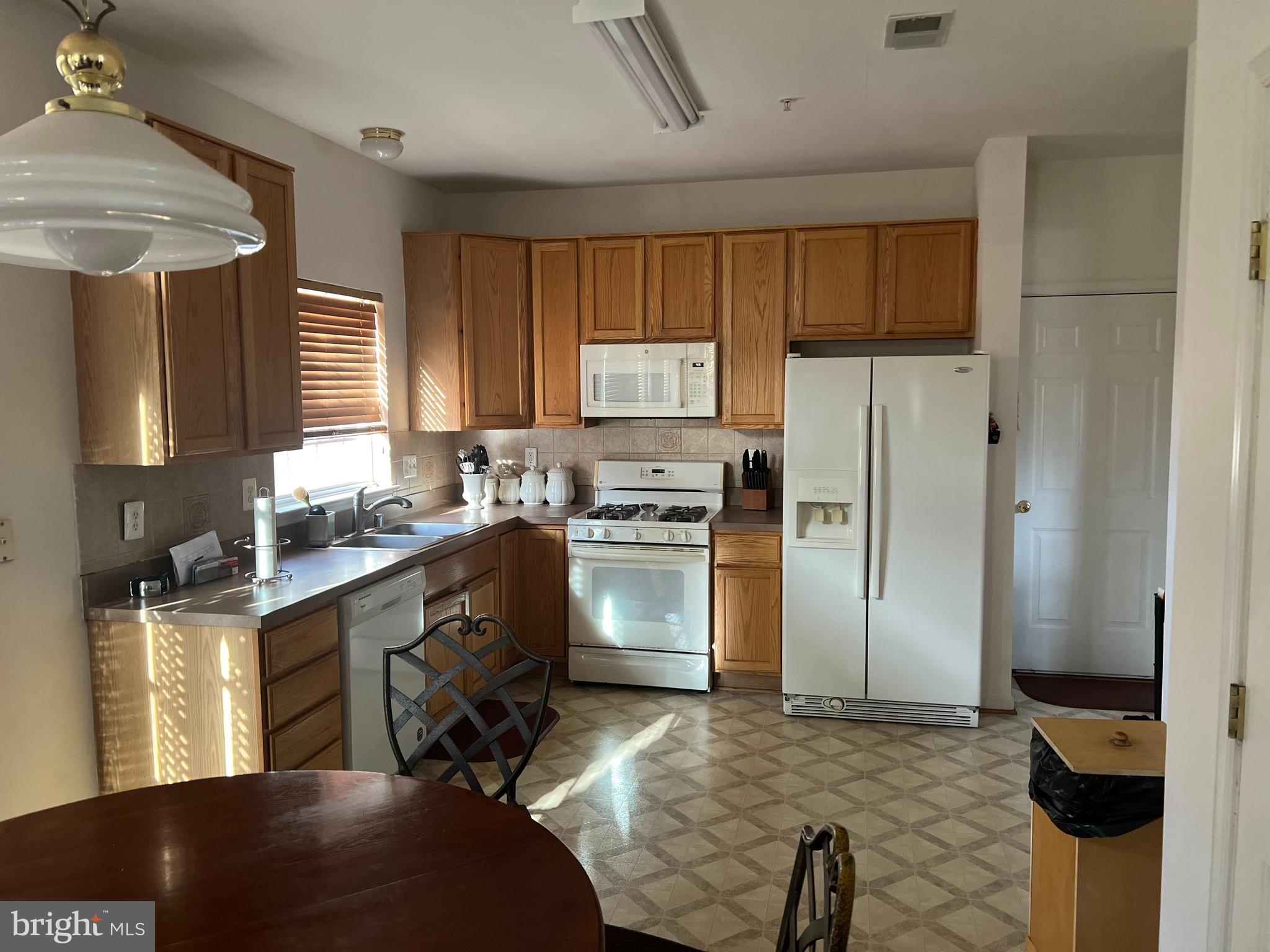 1007 Bohac Lane Accokeek, MD 20607 - Photo 14 of 22 a kitchen with granite countertop a refrigerator stove and sink