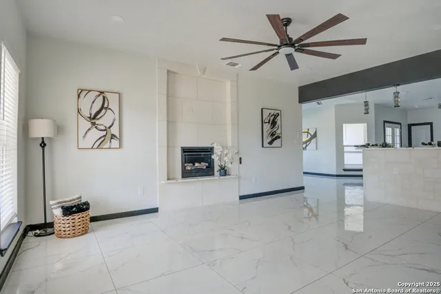 a view of a livingroom with furniture and a ceiling fan