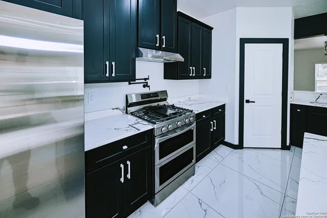 a kitchen with stainless steel appliances a stove and a refrigerator