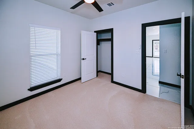 an empty room with windows and closet