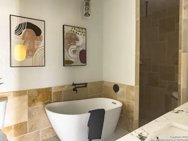 a bathroom with a tub and shower