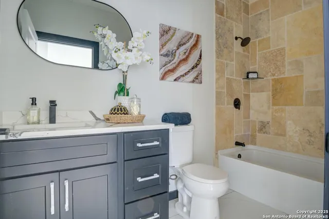 a bathroom with a sink a toilet and a mirror