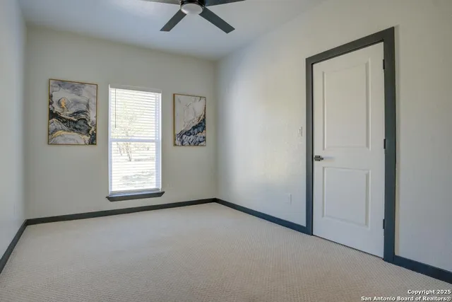 an empty room with windows and closet