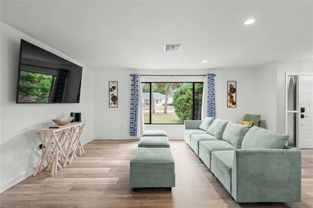 a living room with furniture and a large window