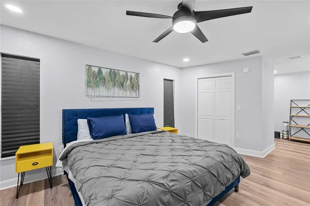 a bedroom with a bed and wooden floor