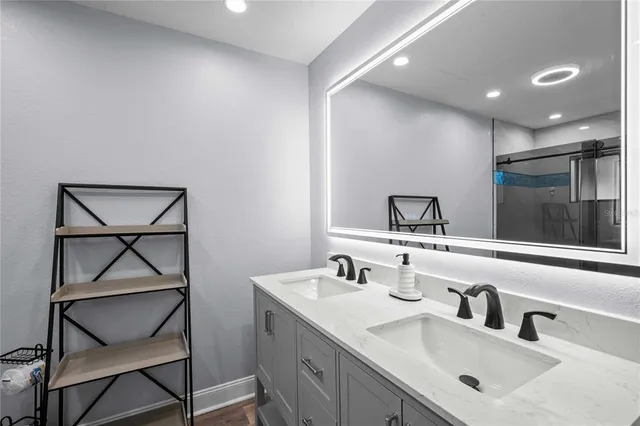 a bathroom with a double vanity sink and a mirror