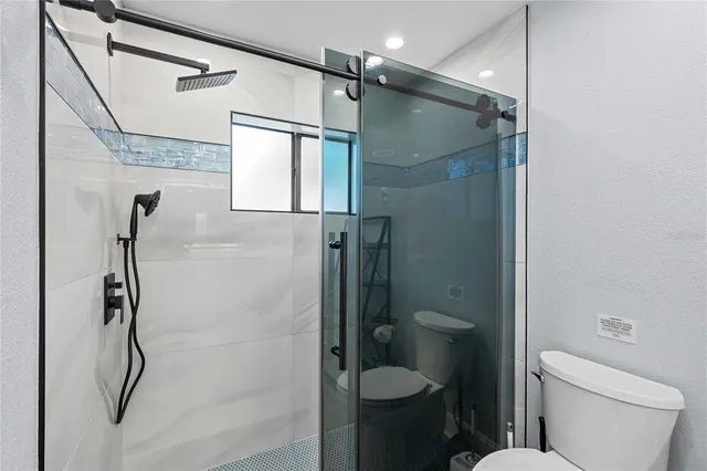 a bathroom with a shower toilet and sink