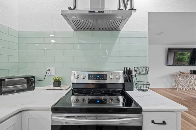 a stove top oven sitting inside of a kitchen