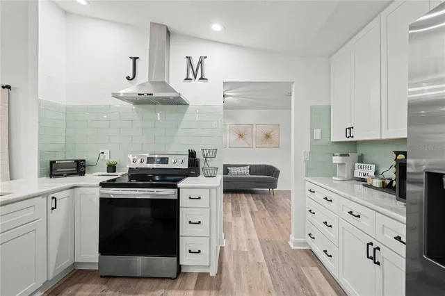 a kitchen with stainless steel appliances a stove a sink and a refrigerator