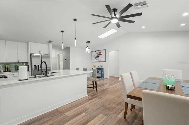 a kitchen with stainless steel appliances granite countertop a sink and cabinets