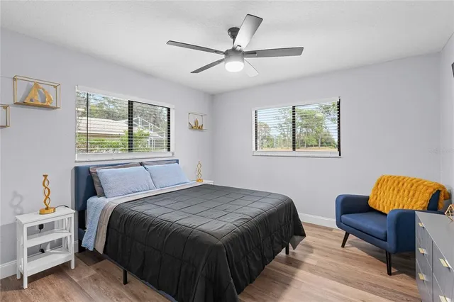 a bedroom with a bed and wooden floor