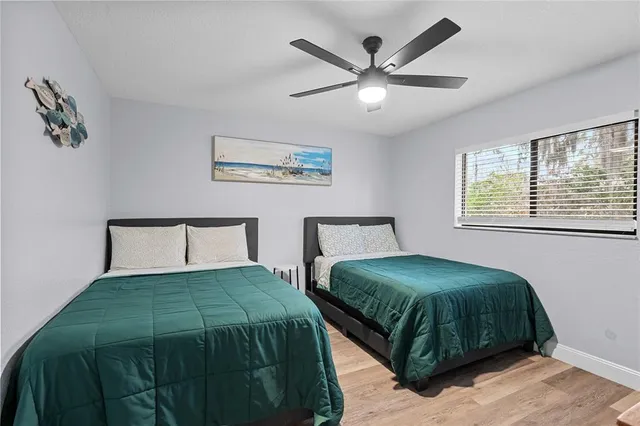 a bedroom with a large bed and a chandelier