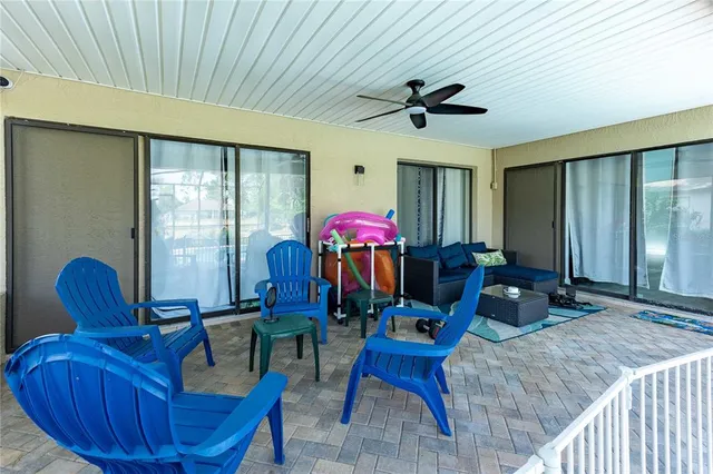 a living room with furniture a chandelier and a window