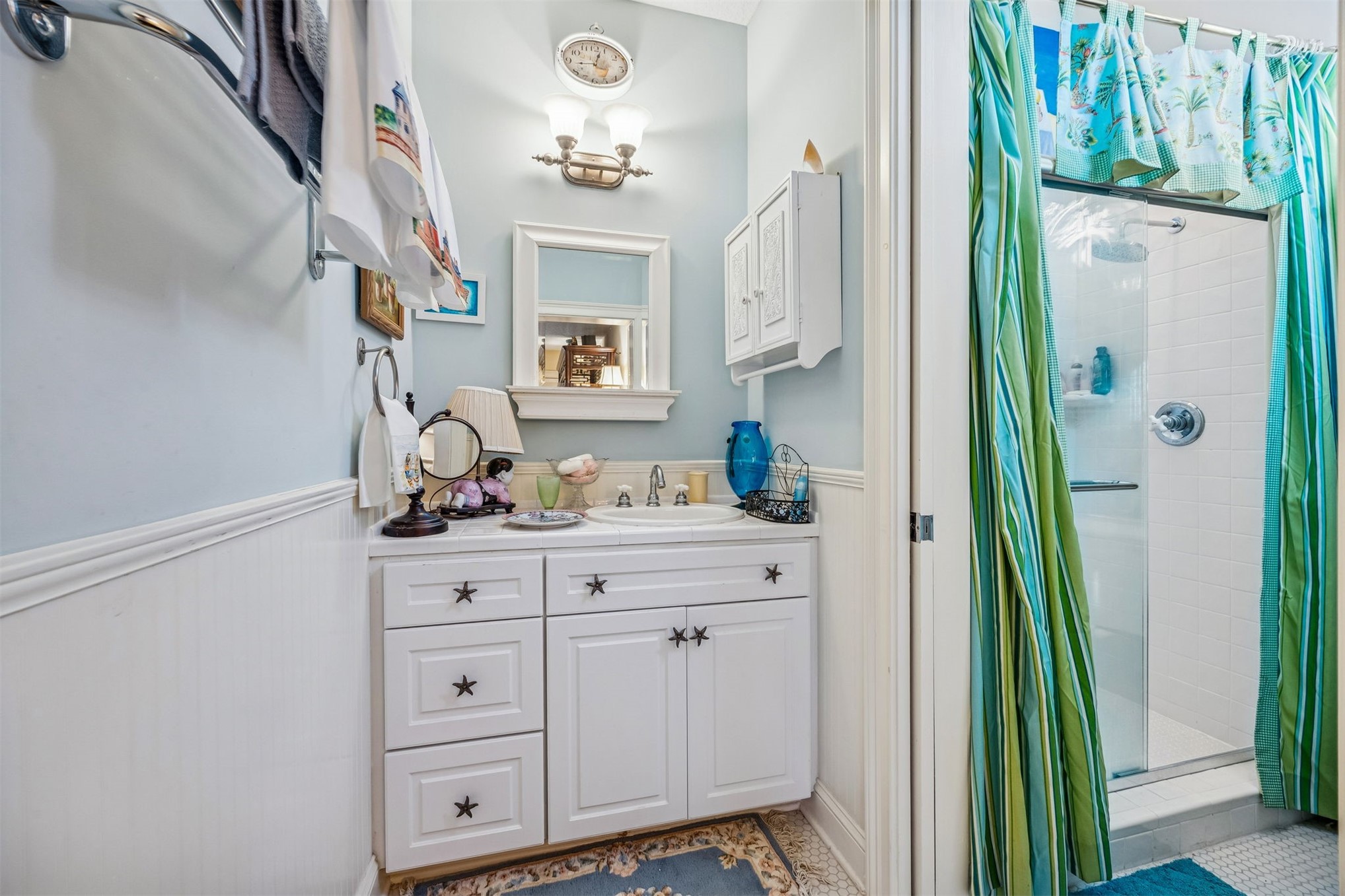 39 Marsh Creek Road Fernandina Beach, FL 32034 - Photo 36 of 78 a bathroom with cabinets a sink and a mirror