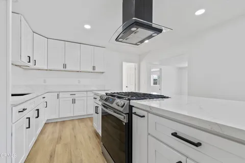 a kitchen with stainless steel appliances granite countertop a stove and a refrigerator