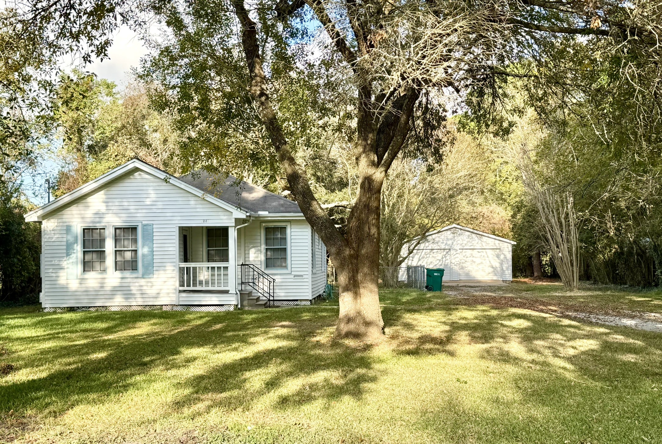 a front view of house with yard and trees around