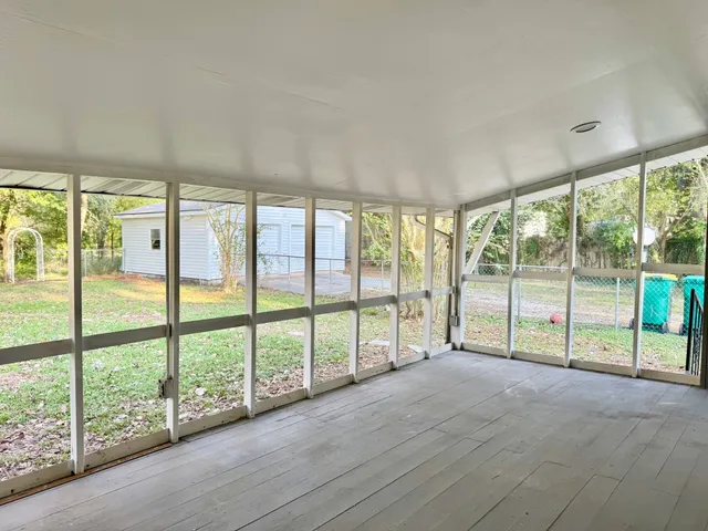 a view of empty room with large windows
