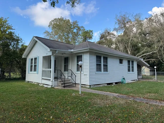 a front view of a house with a garden