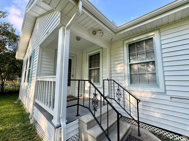 a view of balcony with wooden floor and fence
