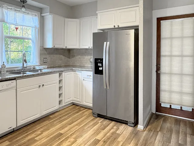 a kitchen with stainless steel appliances a refrigerator and a sink