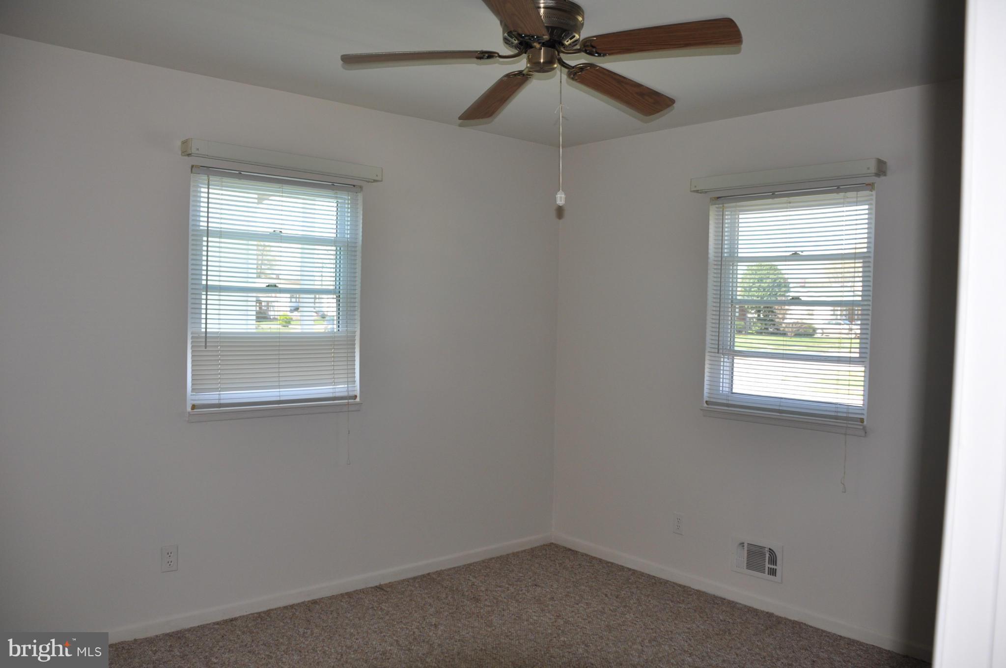 3837 Bayville Road Baltimore, MD 21220 - Photo 9 of 14 an empty room with a window and a fan