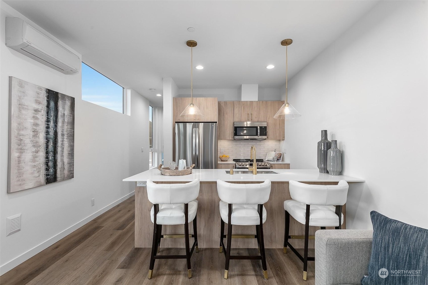 930 Northwest 56th Street Seattle, WA 98107 - Photo 13 of 35 a kitchen with stainless steel appliances kitchen island granite countertop a sink a stove a refrigerator with white cabinets and wooden floor