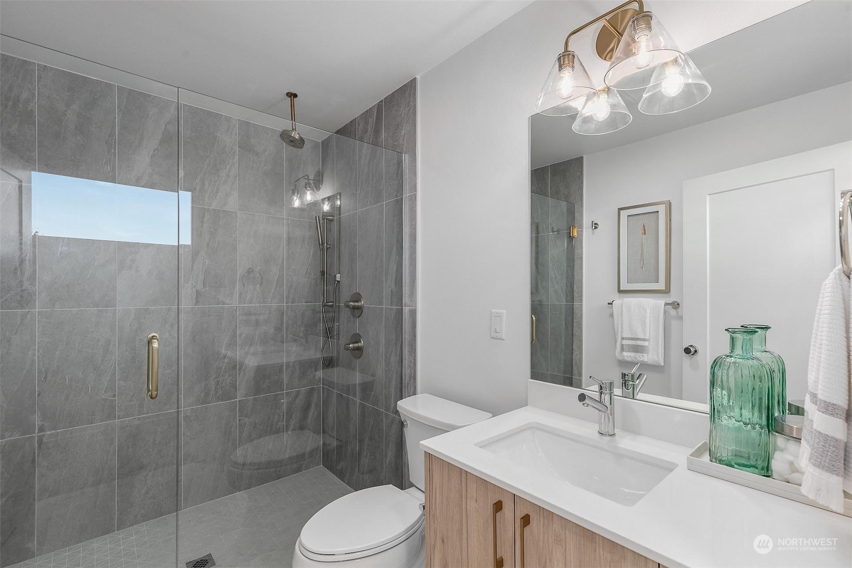 930 Northwest 56th Street Seattle, WA 98107 - Photo 24 of 35 a bathroom with a sink a toilet and shower