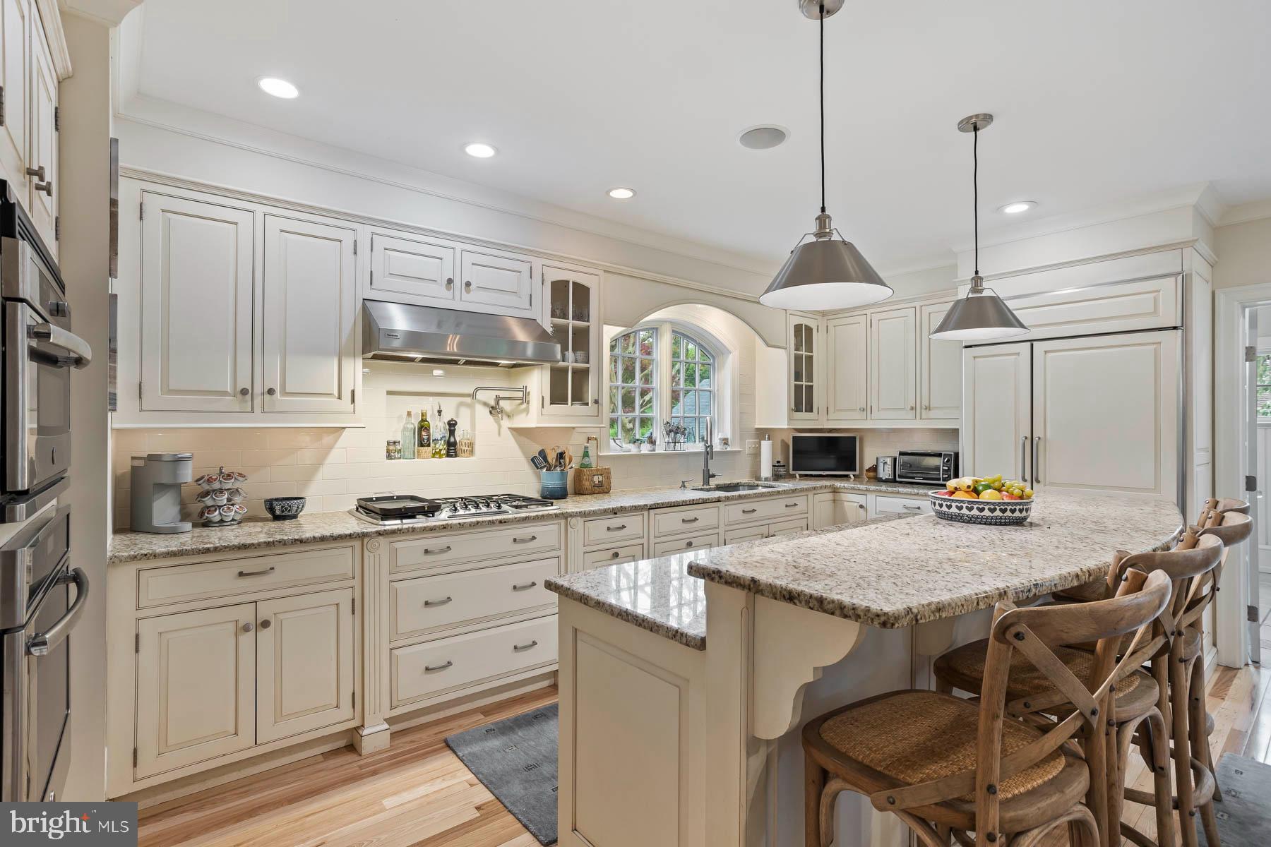 261 Forrest Road Merion Station, PA 19066 - Photo 7 of 43 a kitchen with stainless steel appliances granite countertop a kitchen island a stove a sink a table and chairs