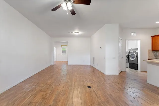 a view of a kitchen with a sink and a refrigerator