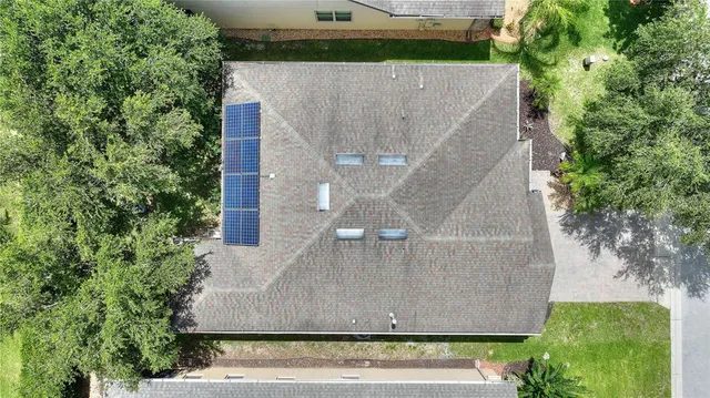 an aerial view of a house with a yard