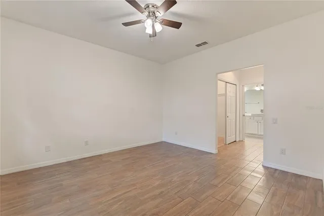 a view of an empty room with wooden floor