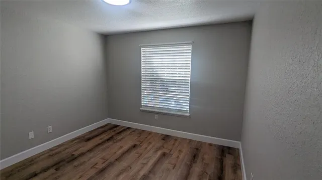 a view of a room with wooden floor
