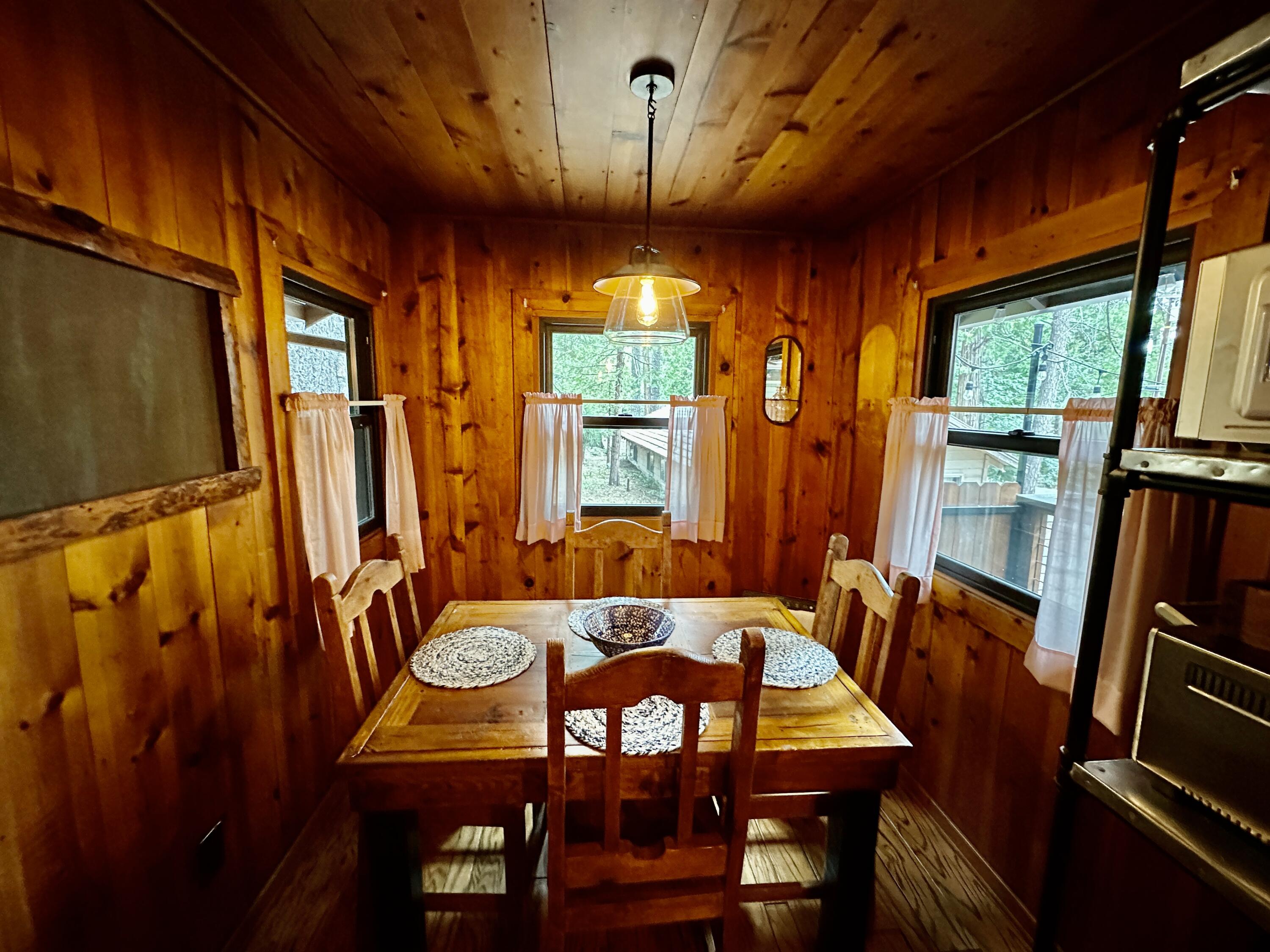 53765 Idyllwild Road Idyllwild, CA 92549 - Photo 13 of 43 a view of a dining room with furniture window and wooden floor