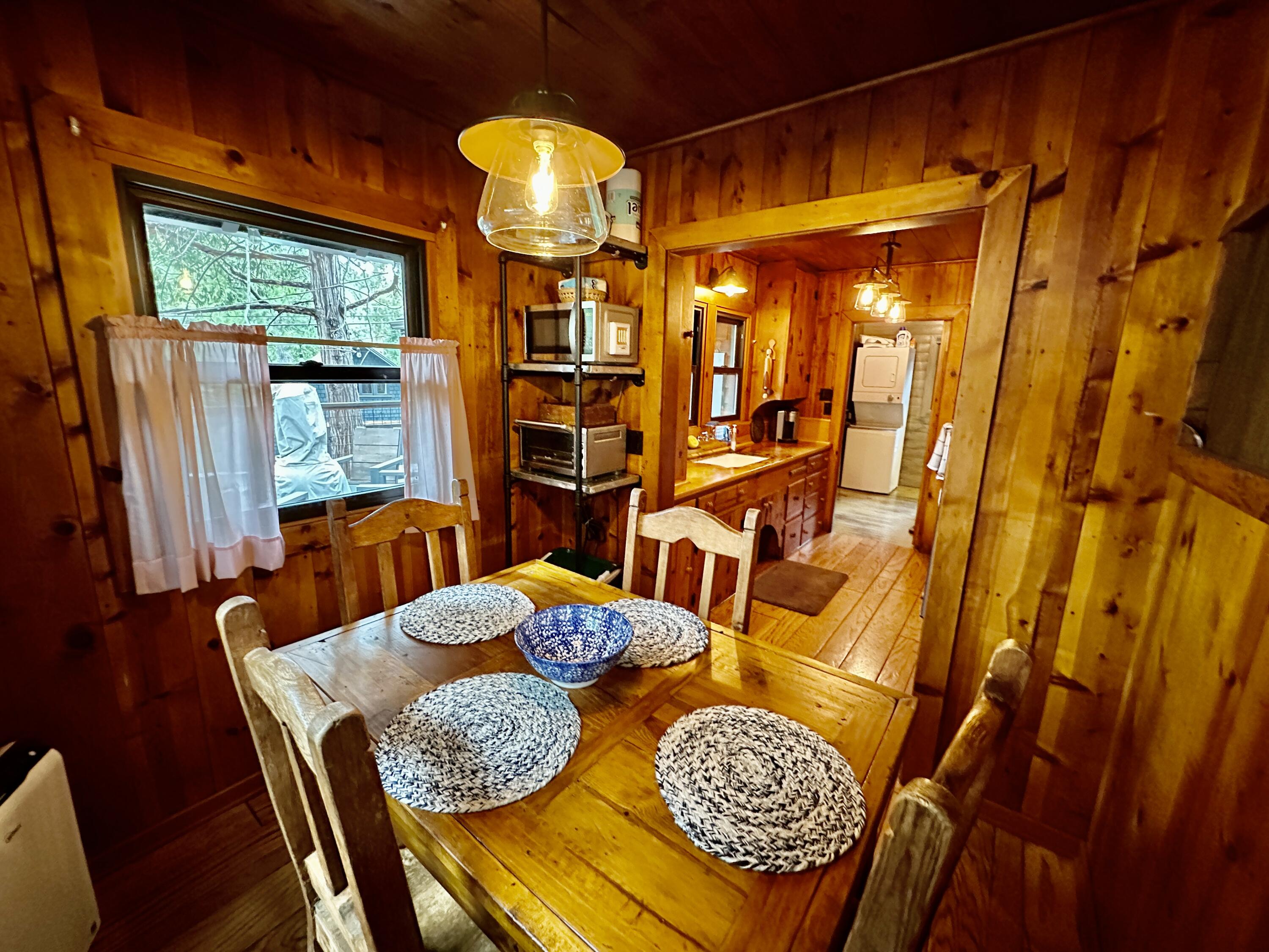 53765 Idyllwild Road Idyllwild, CA 92549 - Photo 15 of 43 a view of a dining room with furniture wooden floor and chandelier