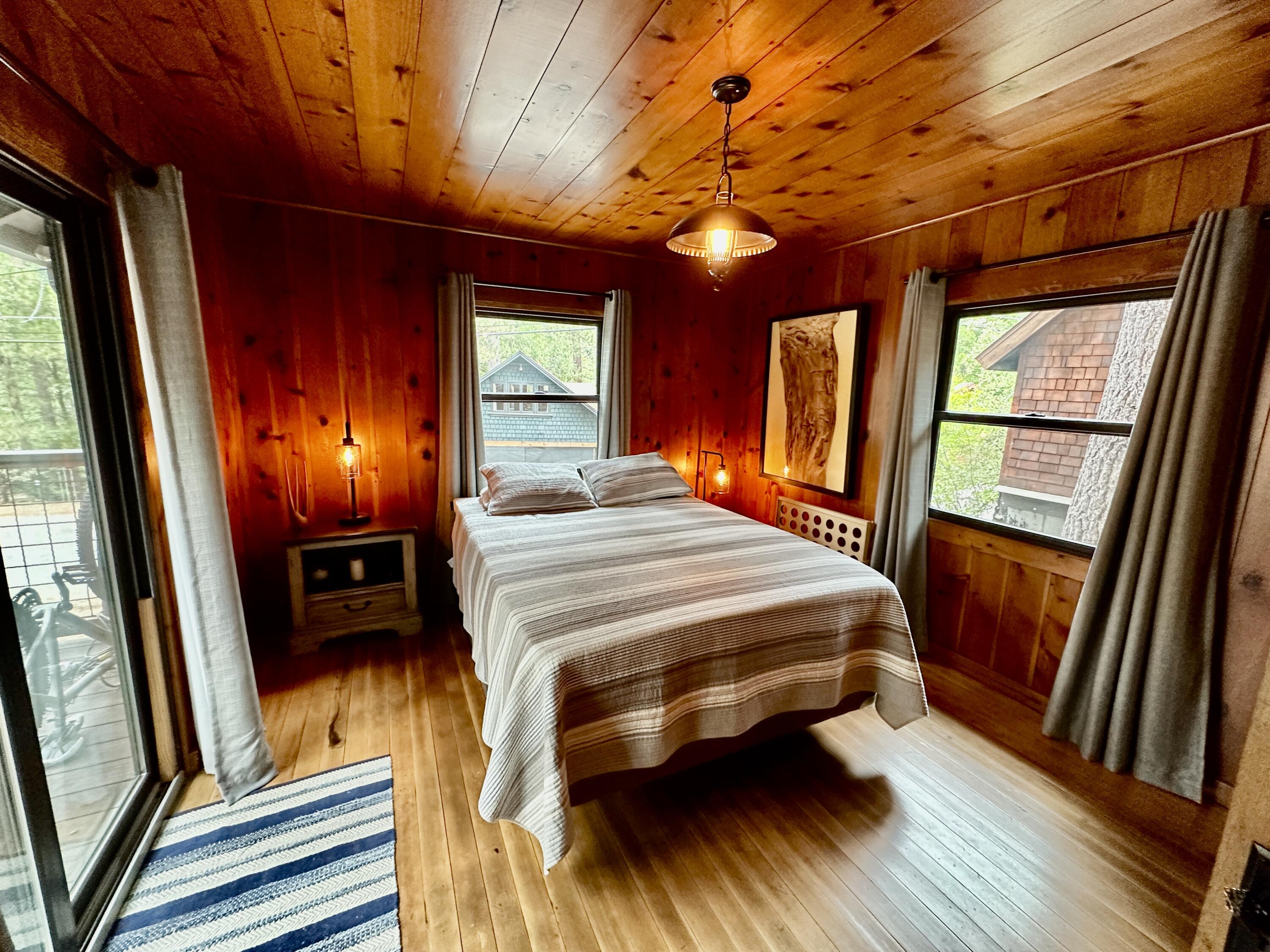53765 Idyllwild Road Idyllwild, CA 92549 - Photo 23 of 43 a bedroom with a bed and wooden floor