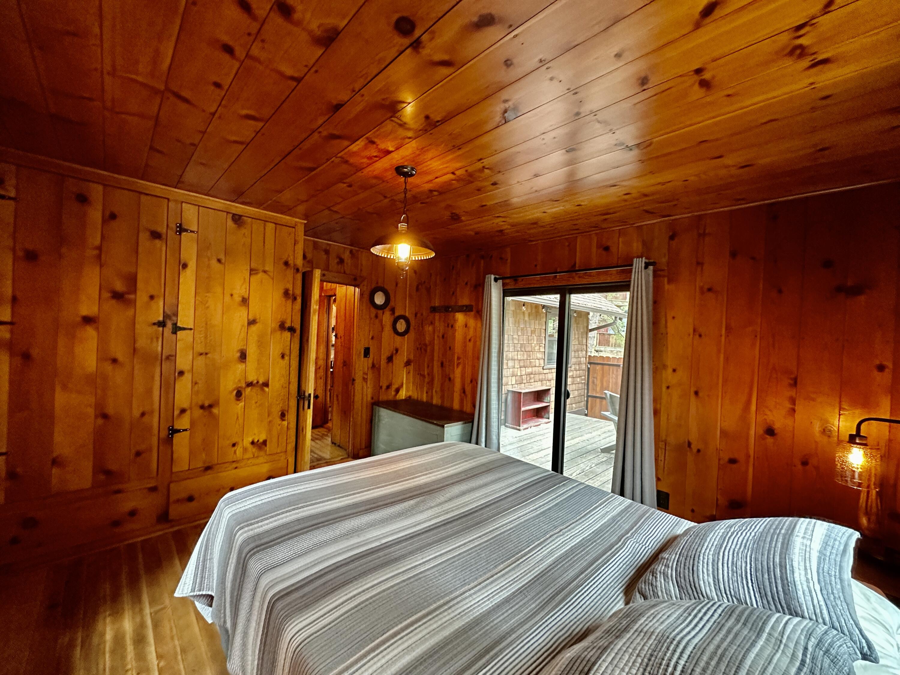 53765 Idyllwild Road Idyllwild, CA 92549 - Photo 25 of 43 a bedroom with a bed and a chandelier