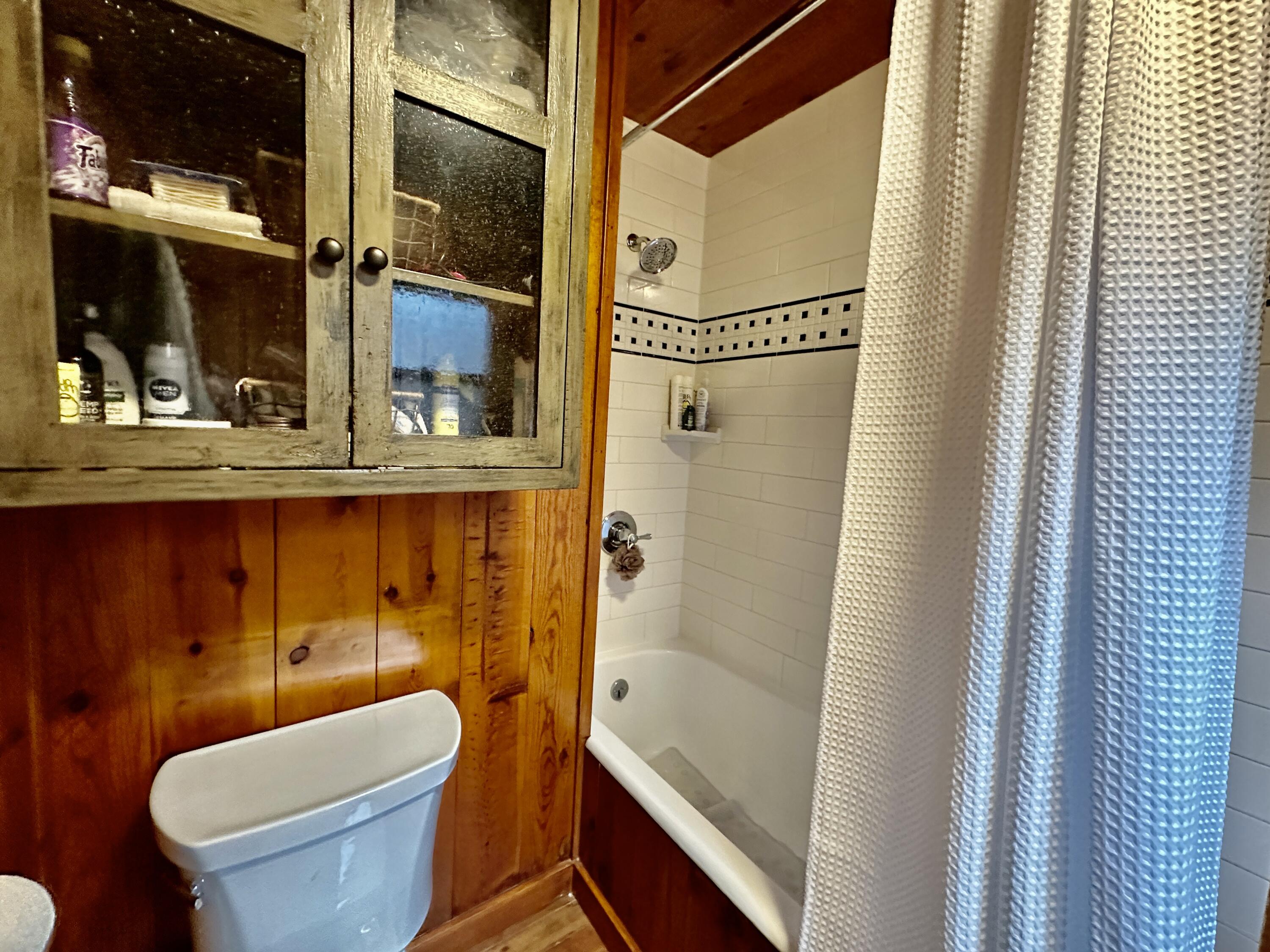 53765 Idyllwild Road Idyllwild, CA 92549 - Photo 35 of 43 a bathroom with a sink a toilet a mirror and shower