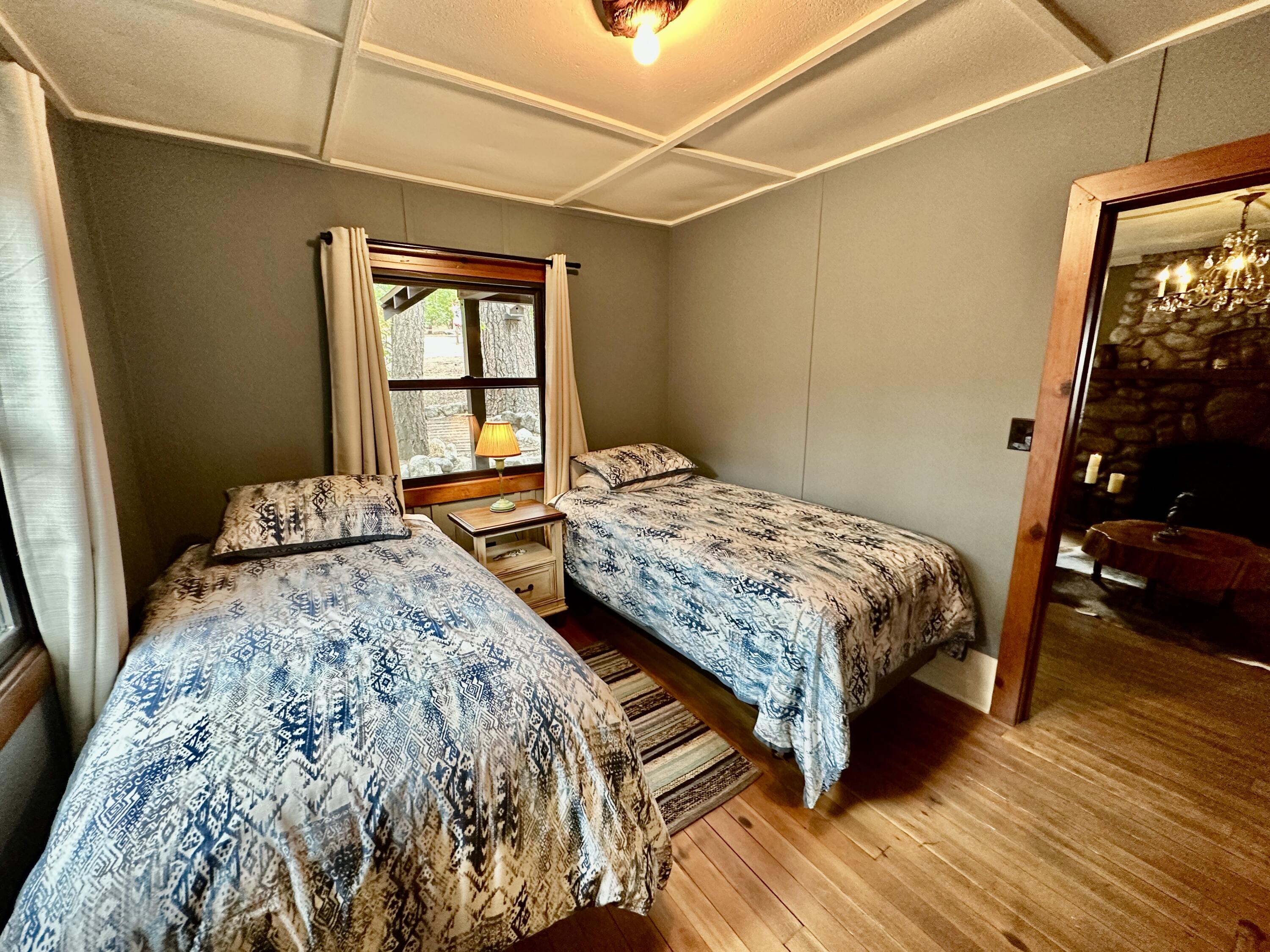 53765 Idyllwild Road Idyllwild, CA 92549 - Photo 38 of 43 a bedroom with a bed and wooden floor