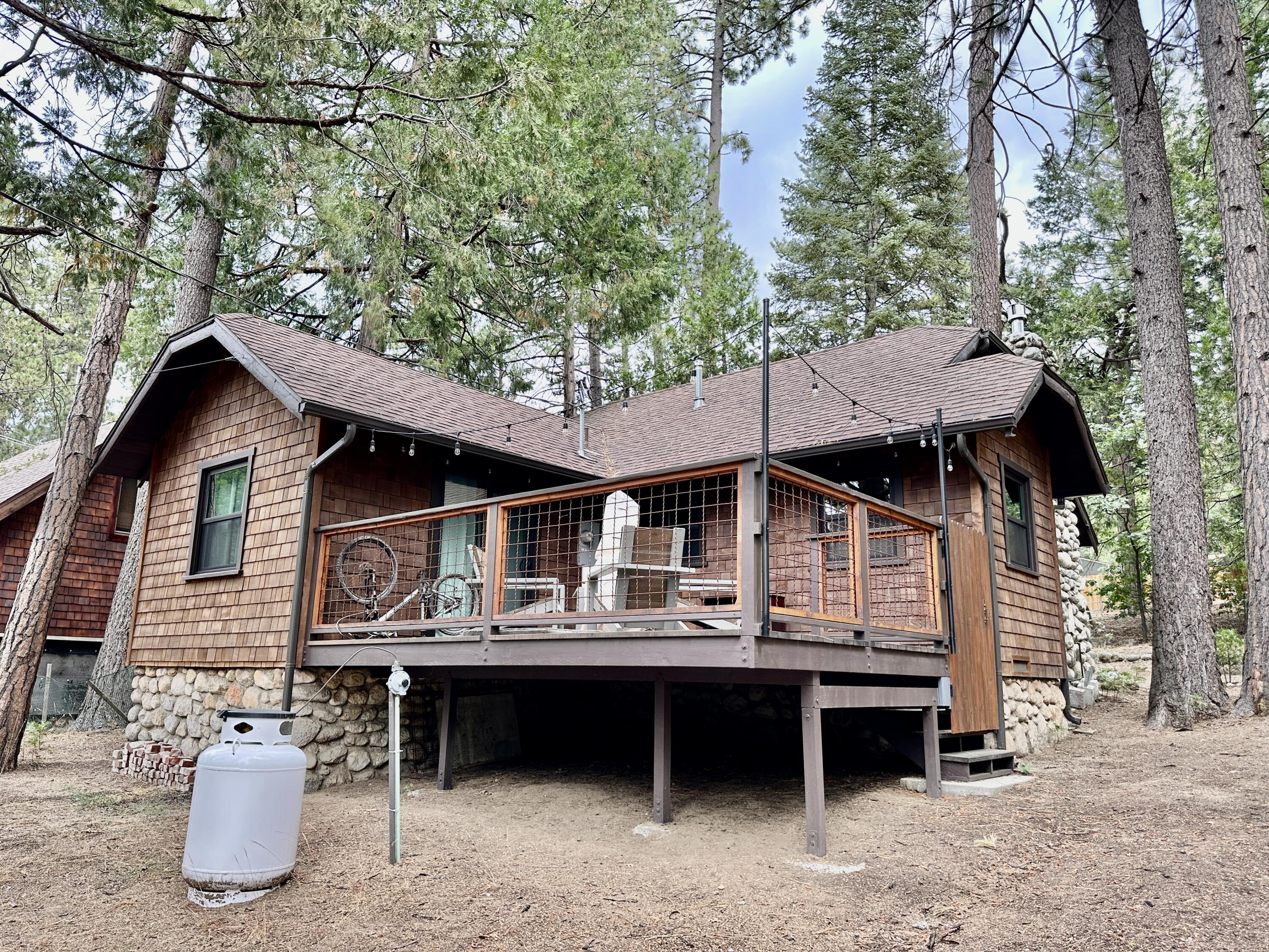 53765 Idyllwild Road Idyllwild, CA 92549 - Photo 42 of 43 a view of house with outdoor seating and trees