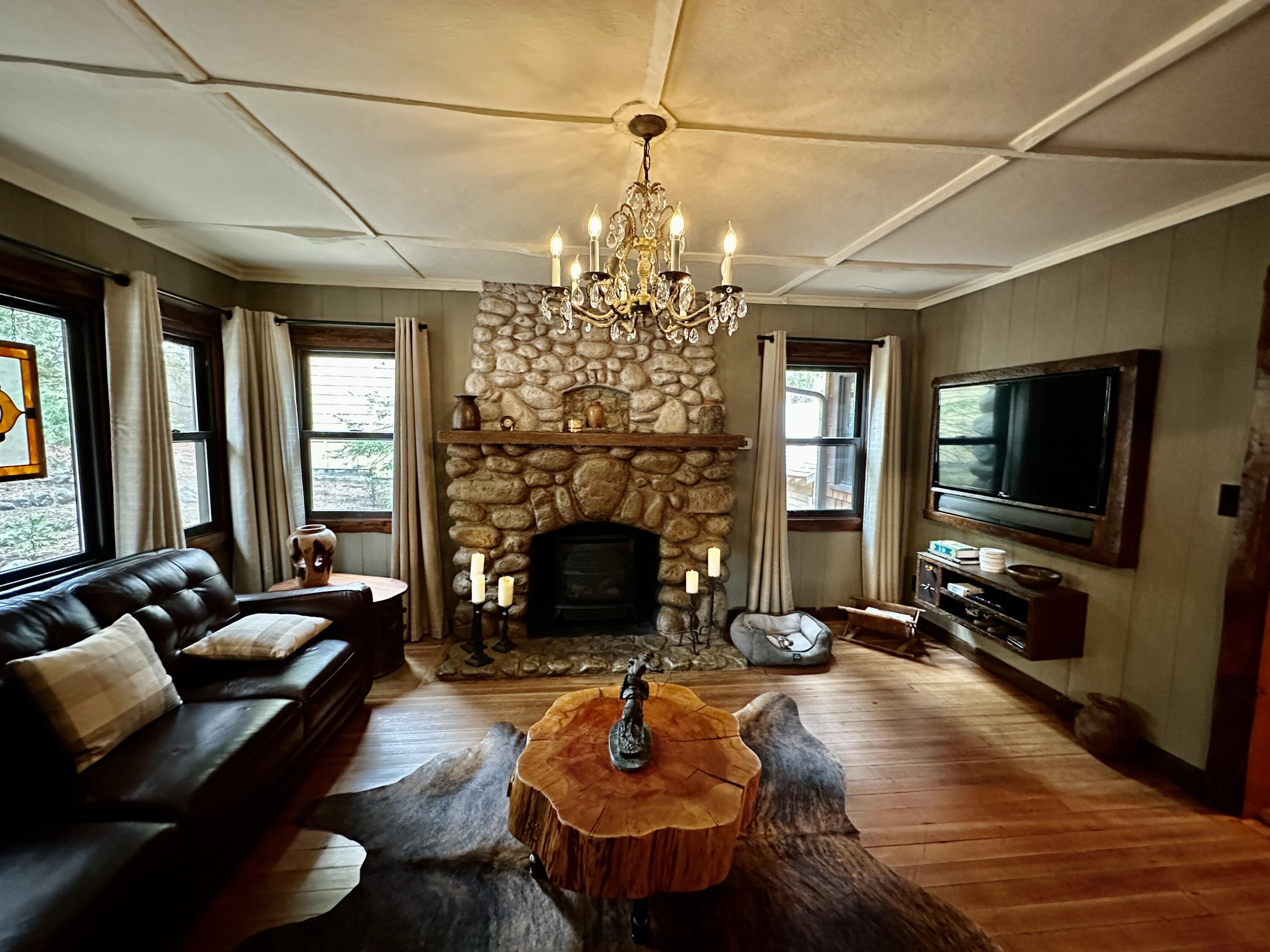 53765 Idyllwild Road Idyllwild, CA 92549 - Photo 7 of 43 a living room with fireplace furniture and a flat screen tv