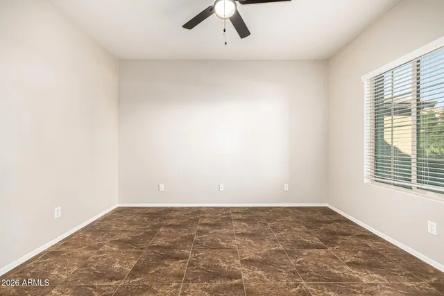 a view of a big room with wooden floor and a ceiling fan